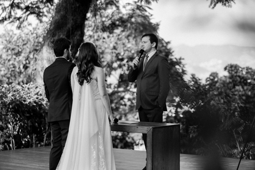 Officiant joining a bride and groom’s hands in a wedding ceremony.